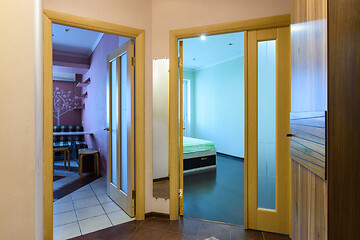 Image showing Layout of a one-room apartment, view from the hallway to open doors to the kitchen and a room in a one-room apartment