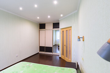 Image showing Bedroom interior, large built-in wardrobe, front door