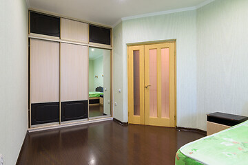 Image showing Fragment of the bedroom interior, view of the wardrobe and the interior door