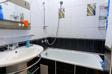 Image showing Classic bathroom interior in an apartment for daily rent, view of the bathroom and washbasin