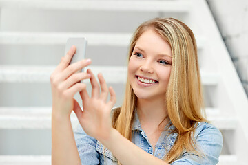 Image showing teenage girl taking selfie by smartphone on stairs