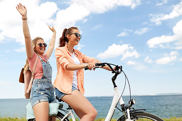 Image showing teenage girls or friends riding bicycle in summer