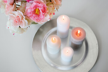 Image showing candles burning on table and flowers at cozy home