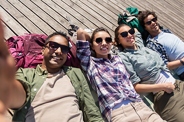 Image showing friends or tourists with backpacks taking selfie