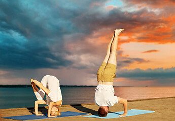 Image showing couple making yoga outdoors