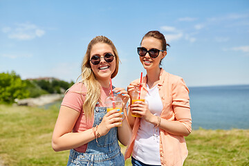 Image showing teenage girls or friends with drinks in summer