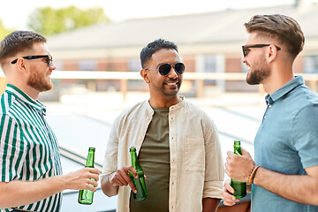 Image showing happy male friends drinking beer at rooftop party