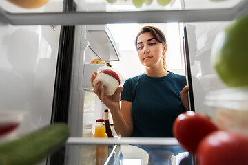 Image showing woman taking food from fridge at home