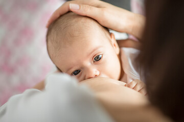 Image showing close up of mother breastfeeding newborn baby