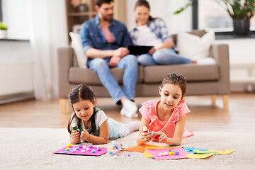 Image showing happy sisters doing arts and crafts at home