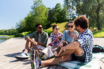Image showing friends hanging out and talking outdoors in summer