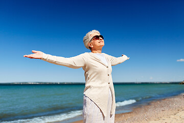 Image showing portrait of senior woman in sunglasses on beach