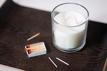 Image showing fragrance candle and matches on tray on table