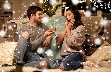 Image showing happy couple with gift box at home