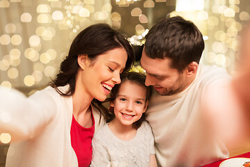 Image showing happy family taking selfie at christmas