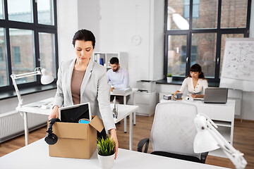 Image showing female office worker with box of personal stuff