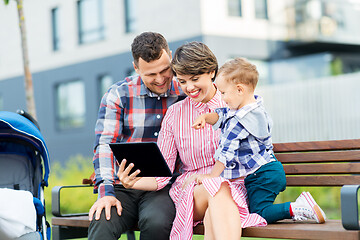 Image showing family with tablet pc sitting on bench in city