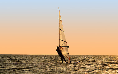 Image showing Silhouette of a windsurfer on waves of a gulf 