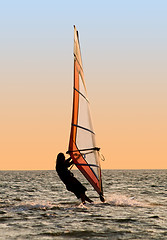 Image showing Silhouette of a windsurfer on a gulf 