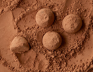 Image showing chocolate truffles on cocoa powder background