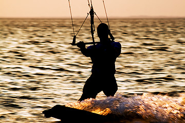 Image showing Silhouette of a kitesurfer on a gulf