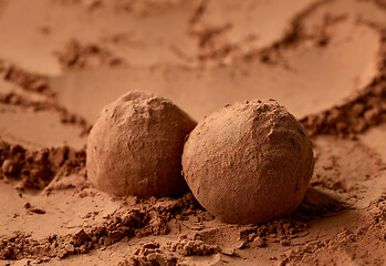 Image showing chocolate truffles on cocoa powder background