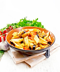 Image showing Pasta penne with eggplant and tomatoes on napkin