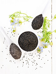 Image showing Seeds of black cumin in bowl on light board top
