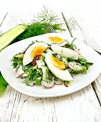 Image showing Salad with radish and egg in plate on wooden board