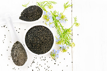 Image showing Seeds of black cumin in bowl on board top