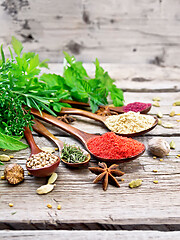 Image showing Spices in spoons on old board