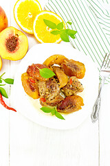 Image showing Turkey with peaches in plate on light board top