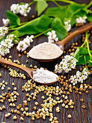 Image showing Flour buckwheat green and brown in spoons on wooden board