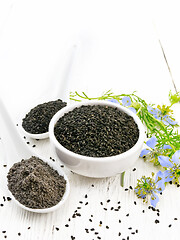 Image showing Seeds of black cumin in bowl on white board