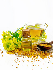 Image showing Oil mustard in jars and gravy boat on board