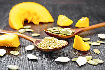 Image showing Flour and seeds pumpkin in spoons on board