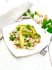 Image showing Salad of avocado and champignons on light wooden board