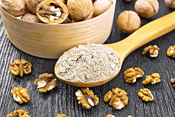 Image showing Flour walnut in spoon on dark wooden board