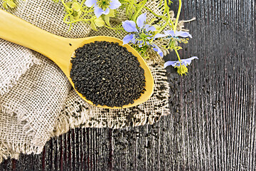 Image showing Seeds of black cumin in spoon on board top