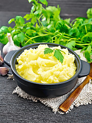 Image showing Potatoes mashed in saucepan on wooden board