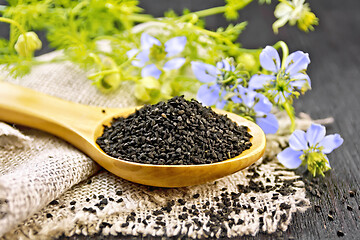 Image showing Seeds of black cumin in spoon on board