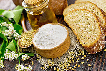 Image showing Flour buckwheat green in bowl with bread on wooden board