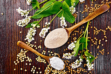 Image showing Flour buckwheat brown and green in spoons on wooden board top