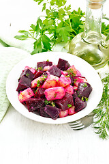 Image showing Salad of beets and potatoes in plate on light board