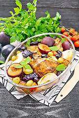 Image showing Chicken with fruits and tomatoes in glass pan on dark board