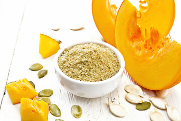 Image showing Flour pumpkin in white bowl on wooden board