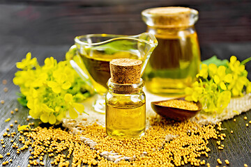 Image showing Oil mustard in two jars and gravy boat on board