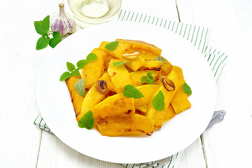 Image showing Pumpkin with garlic in plate on light board