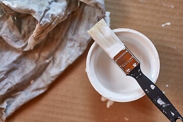 Image showing Paint brush on a can of white wall paint