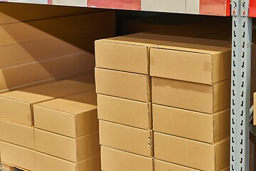 Image showing Warehouse stocked with boxes in stacks